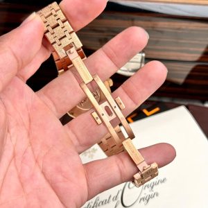 a person's wrist with gold watches